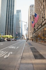 Flat design is showing downtown avenue with glass towers, pedestrian walking, flags