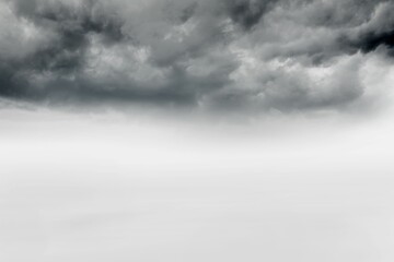Dark textured storm clouds are gathering over wide open foggy plain in flat design illustration