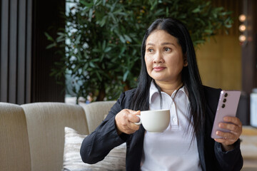 Asian businesswoman in cafe restaurant drinking coffee