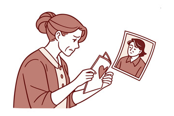 A Moment of Reflection: A woman gazes with tender eyes at a cherished card, accompanied by a framed photograph, capturing a moment of nostalgic intimacy.