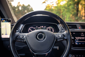 Modern car interior. Steering wheel close-up. Driving tech setup.