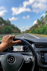 Driver hand on steering wheel. GPS navigation. Motion on highway.