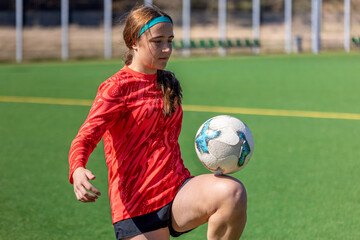 Girl on the soccer field. Soccer training. Active lifestyle. Football concept.