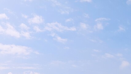 Blue sky background with white clouds in summer. Soft white clouds float in the clear blue sky. Focus on clouds. Full frame shot. Heaven sky bright blue sky background.