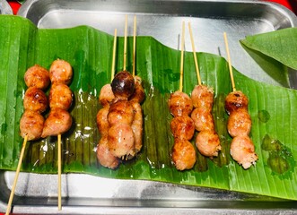 Isan sausage or grilled meatballs on a stick, a Thai street food..