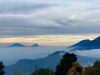 Mount Prau View, Indonesia, captured on July 3, 2025. A breathtaking highland scene with rolling hills, golden sunrise, and panoramic clouds above the peaks of Central Java.

