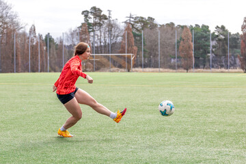 Girl on the soccer field. Soccer training. Active lifestyle. Football concept.
