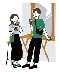 街角のコーヒースタンドでアイスコーヒーを飲む男女