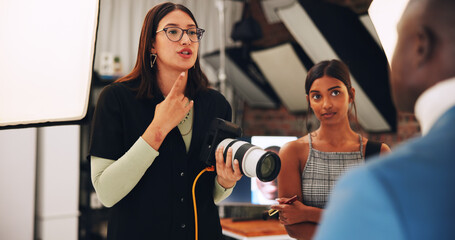Women, photographer or direction with model for photoshoot, planning or behind the scene. People,...