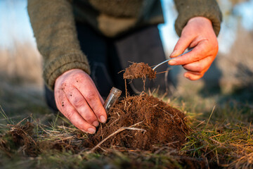 women in agriculture looking at a soil sample. girl on a farm looking at plant roots, female farmer...