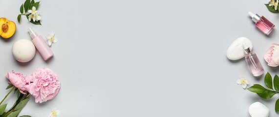 Different cosmetic products, flowers and spa stones on light background with space for text