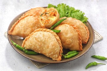 Pastel Goreng in Indonesia, pastel refers to a type of kue filled with meat, vegetables, and rice vermicelli deep fried in vegetable oil. It is consumed as a snack and commonly sold in Indonesian trad