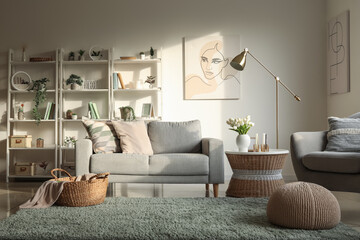 Interior of light living room with sofa, shelving units and artificial plants