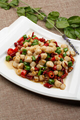 Dry-pot spicy duck head in iron pot