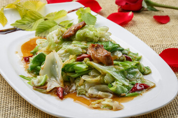 White round porcelain plate with stir-fried lamb and green onions
