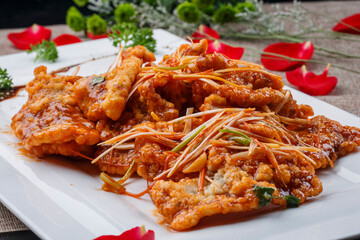 Crispy pot-fried pork in a white rectangular porcelain plate