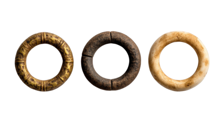 Three ancient decorative rings displayed on a neutral background, showcasing intricate designs and textures