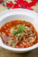 Spicy beef stewed with sea sausage in a white porcelain soup bowl