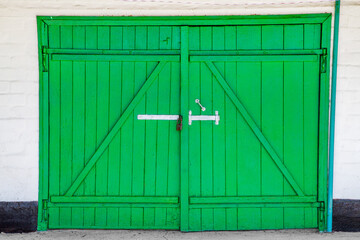 Green wooden garage door. Garage doors made of wooden boards.