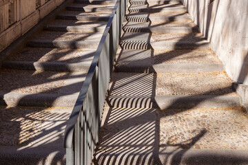 Sunlight Casts Diagonal Shadows from Handrail in Madrid Spain