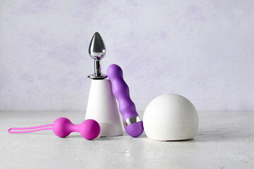 Decorative podiums with sex toys on light table