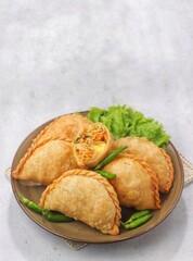 Pastel Goreng in Indonesia, pastel refers to a type of kue filled with meat, vegetables, and rice vermicelli deep fried in vegetable oil. It is consumed as a snack 