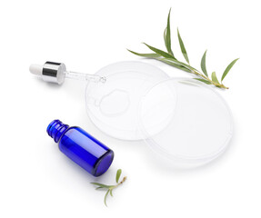 Petri dishes with plant leaves and bottle of cosmetic product on white background