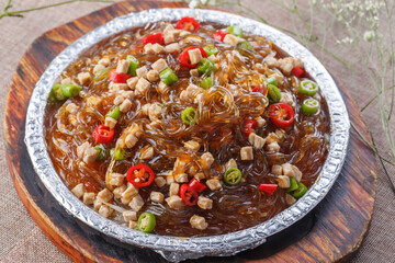 Spicy diced chicken crystal powder in tin foil on wooden pallet