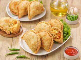 Pastel Goreng in Indonesia, pastel refers to a type of kue filled with meat, vegetables, and rice vermicelli deep fried in vegetable oil. It is consumed as a snack 