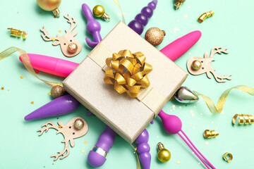 Gift box with sex toys and golden Christmas decor on turquoise background