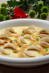 Steamed egg with seafood and clam meat on white porcelain plate