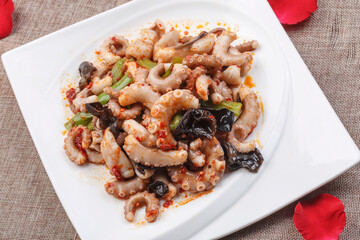 Fried octopus with XO sauce on a white square porcelain plate