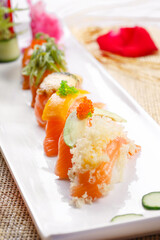 Assorted salmon nigiri sushi on a straw mat