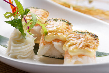 Cheese baked shrimp sushi placed on the sushi curtain