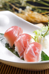 Tuna sushi on a sushi curtain