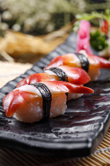 Arctic scallop sushi placed on the sushi curtain