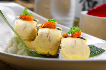 Miss Tamago's seaweed egg omelette sushi is placed on a straw mat