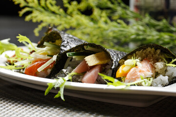 Grilled eel assorted seaweed rolls placed on a placemat