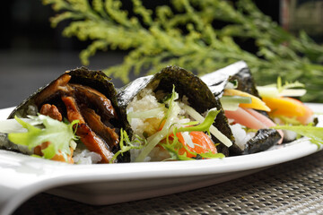 Grilled eel assorted seaweed rolls placed on a placemat