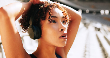 Breathing, fatigue and music with woman in sports stadium for break, recovery or rest from...