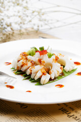 Japanese style grilled squid rolls on English wrapping paper