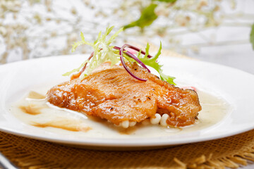 Grilled codfish with teriyaki sauce on a straw mat