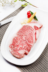 Top-grade A5A3 marbled steaks are placed on the placemat