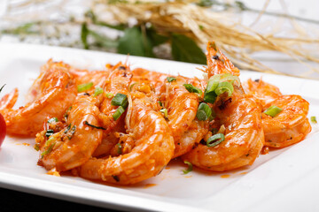 Sizzling South American shrimps on a plate placed on a placemat