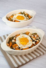 Recipe for kale, carrot and garlic poellee, chopped hazelnuts, cashews and almonds, and fried egg with toasted garlic bread and olive oil