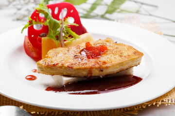 French Landes foie gras with red wine sauce on a straw mat
