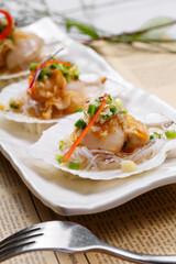 Steamed scallops with garlic vermicelli and XO sauce on English wrapping paper