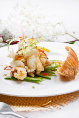 Spicy grilled lobster tail meat on a straw mat