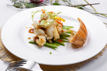 Spicy grilled lobster tail meat on a straw mat