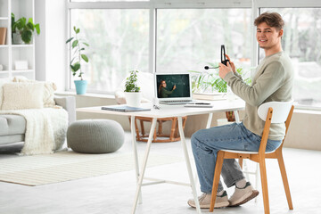 Male student with headset studying Math online at home